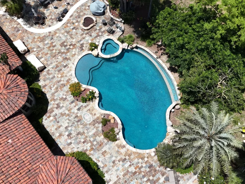 Aerial Shot Of The Mini Pebble Aqua Blue Pool Project Finished And The Pool Filled Up