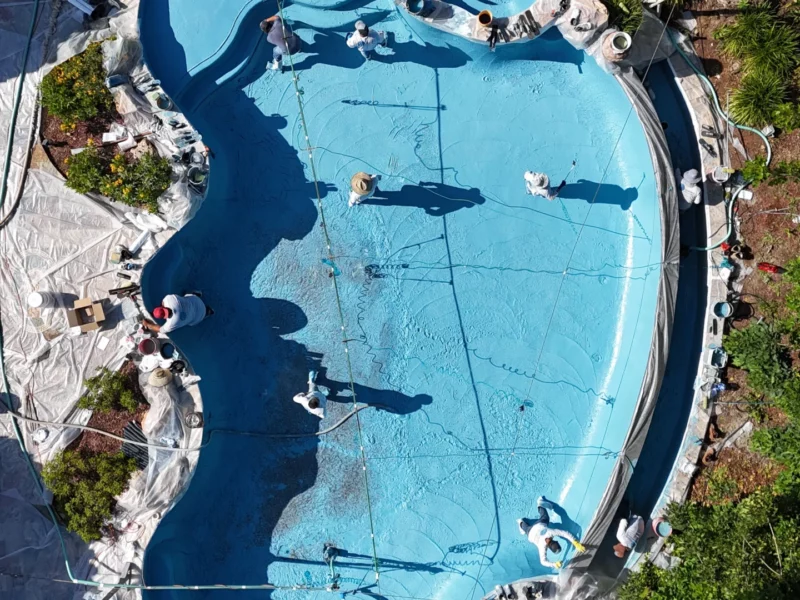 Aerial Drone Shot Of A Pool Plaster Project, It Features Mini Pebble Aqua Blue Pool Plaster